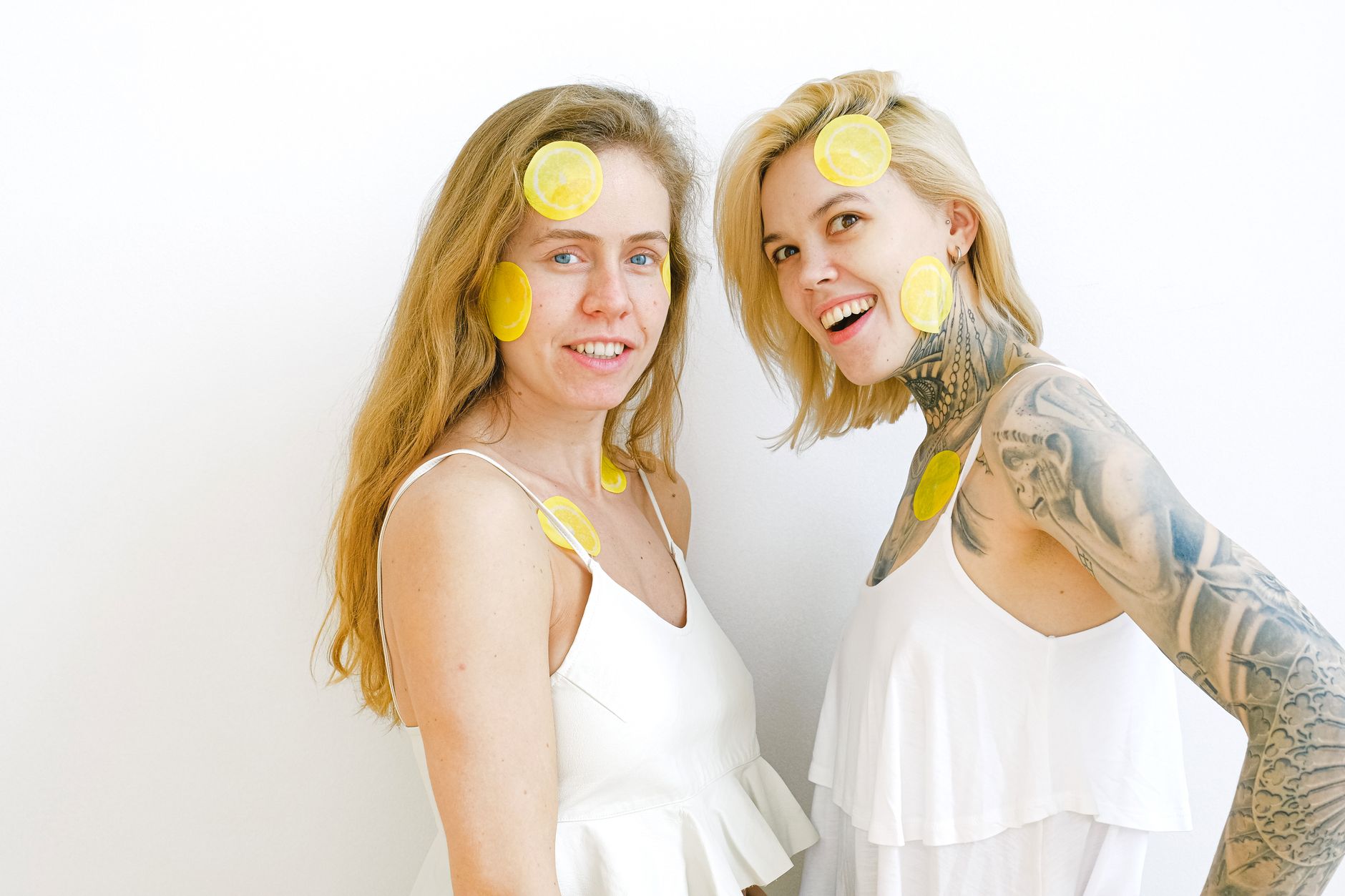 Bright yellow lemons arranged on a pastel green background, symbolizing fresh pleasure solutions