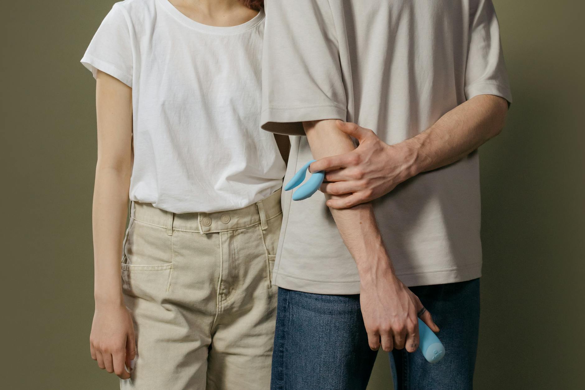 Hands holding a blue personal massager, representing reclaiming pleasure after medication change