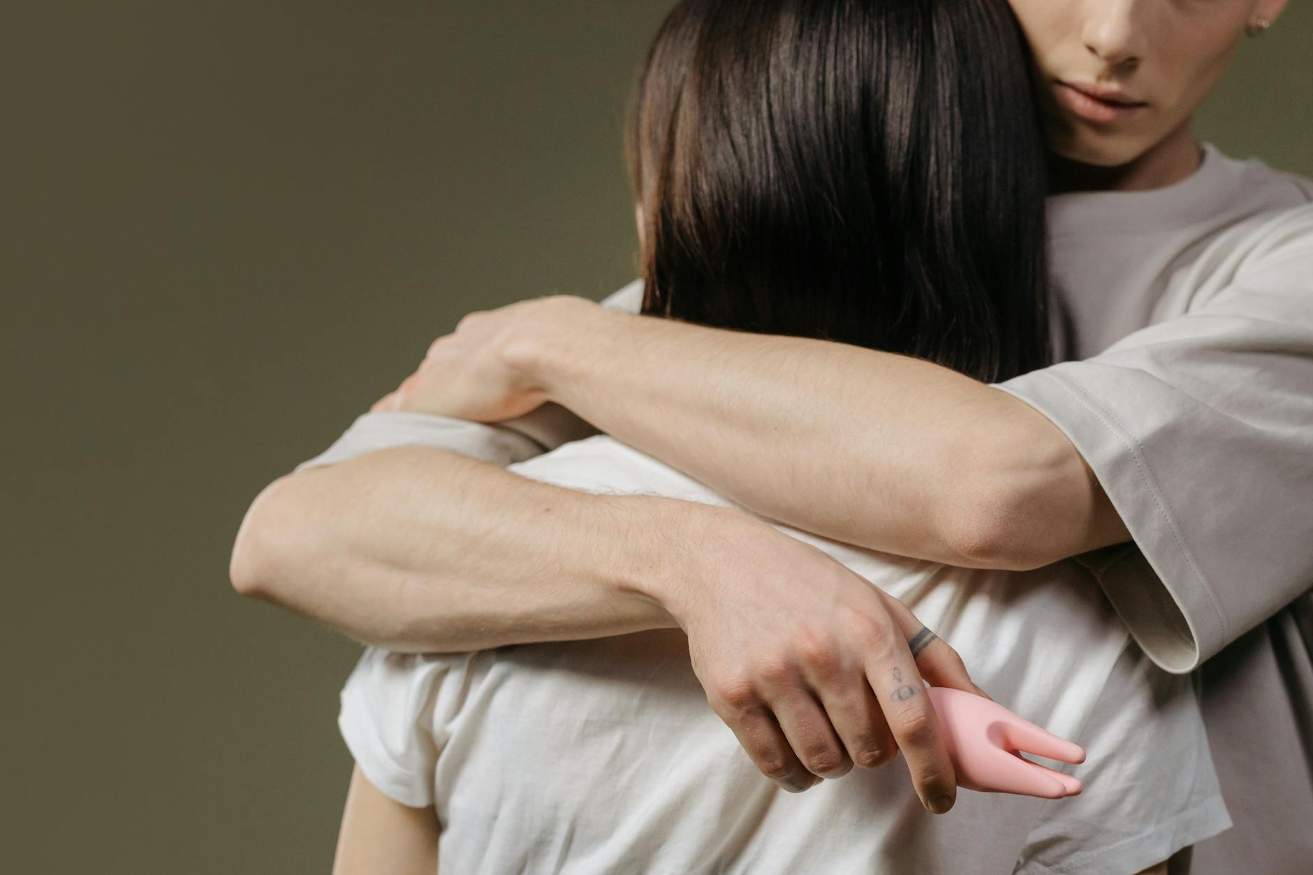 A couple embracing with intimacy and vulnerability, representing partnership and trust during intimate moments.